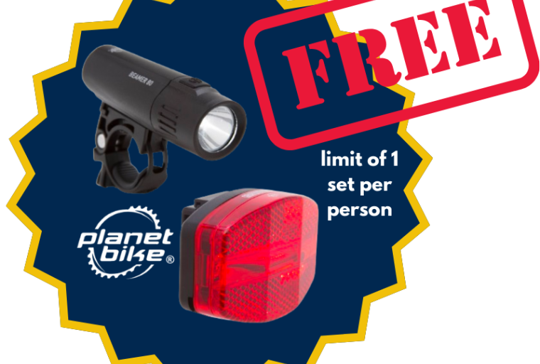 Free in red text, positioned on top of a maize & blue cut out with images of a front and rear bike lights. Text adjacent to the images states the Planet Bike logo and "limit of 1 set per person"