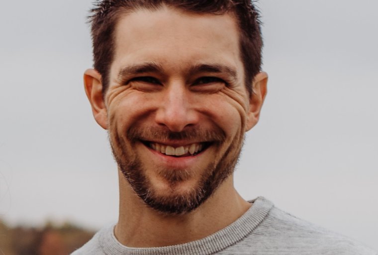 Adam Reimer headshot: white man with short dark brown hair and beard.