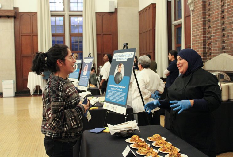 Photo of Michigan Dining chef speaking to an event attendee at the 2025 Food as Resistance event.
