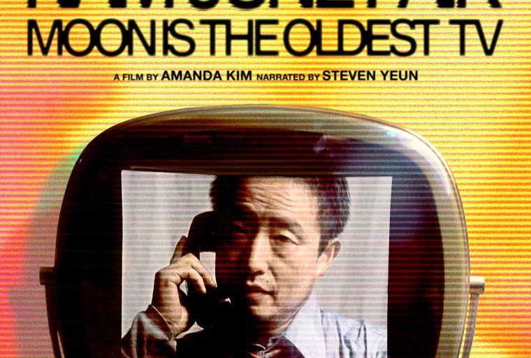 This vertical movie poster for the documentary "Nam June Paik: Moon is the Oldest TV" features a vibrant, retro-analog aesthetic defined by warm yellow and orange tones and heavy horizontal scan lines mimicking an old television screen. The top half displays the title in bold black lettering, accompanied by high-praise quotes from Variety and The Hollywood Reporter and credits for director Amanda Kim and narrator Steven Yeun. Centrally, a vintage CRT television houses a black-and-white portrait of the artist, Nam June Paik, holding a telephone to his ear, while a color-photographed hand reaches in from the right to touch the set. The bottom section is grounded by prestigious film festival laurels from Sundance, MoMA, and CPH:DOX, followed by a standard credit block, all coming together to evoke a sense of nostalgic, technological innovation.