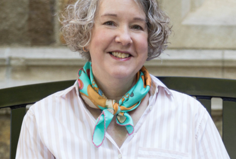 Professional headshot of Dr. Laura Lamps smiling in business attire, conveying a warm, knowledgeable, and approachable presence.