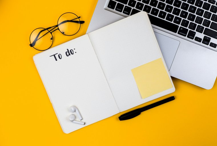 Home office desk workspace with laptop on yellow background. Flat lay, top view girl boss work business concept. Work at home concept on coronavirus quarantine