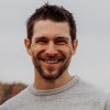 Adam Reimer headshot: white man with short dark brown hair and beard.