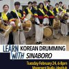 Twelve students pose with drums in traditional Korean costume