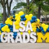 Photo station with "LSA Grads" marquee letters and balloons