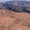 Overview of the archaeological site of Humayma, an ancient settlement in Jordan, with mountains rising in the background.