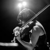 MPulse Faculty Showcase (B&W of woman plucking violin strings with bow in hand.)