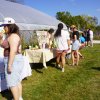 Organizations tabling on a sunny day in front of a hoop house