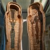 View of the open coffin of Djehutymose, showing painted depictions of the ancient Egyptian goddesses Nut and Amentet standing, surrounded by rows of hieroglyphs. Nut has her hands and hair raised above her head, while Amentet walks in profile with a falcon on her head.