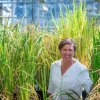Pamela Ronald standing in front of rice plants