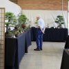 Man looking at a bonsai display.