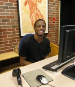 A student employee working at the Hatcher Library South entrance