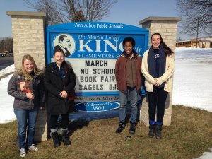 Photo of volunteers in front of King Elementary sign