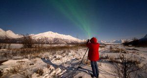 Salgado photographing aurora on a snow covered landscape