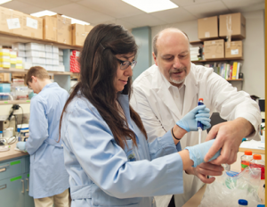 A graduate student and her mentor in a biomedical lab.