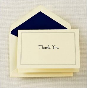 Note card and envelope with the words "Thank you" written on the cover