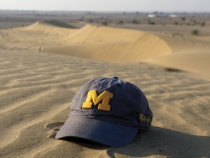 Michigan cap on a desert sand dune