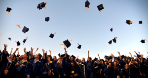 graduation caps in air