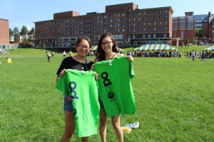 Two students holding up Rec Sports Expo shirts