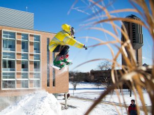 Student snowboarding on North Campus