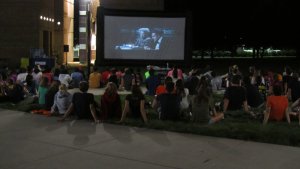 Students watching film outside