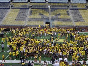 Students on football field in Big House