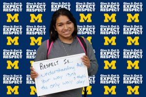 Photo of student holding a sign that showing a handwritten statement of what respect means to them.