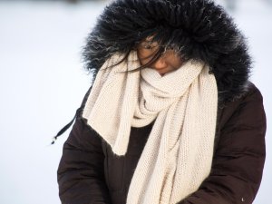woman with scarf and warm coat in the snow
