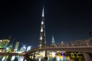 skyline photography of bridge near Burg Khalifa Tower at nighttime