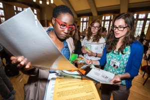 Students look at papers and discuss