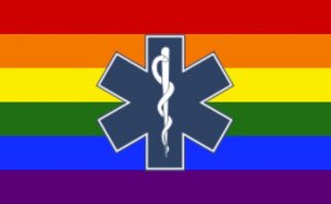 the healthcare symbol in front of the rainbow flag