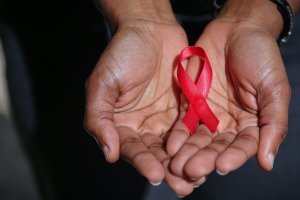 hands holding a red ribbon