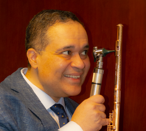 Dr. David Brown 'examines' his flute with his otoscope.