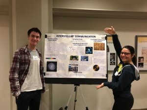 Students Showing Interstellar Communication Poster