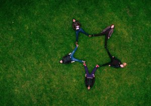 Students laying on lawn together