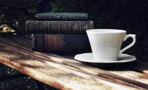 Teacup and saucer with books