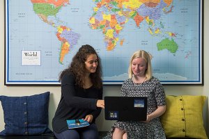 Student and staff member collaborating on computer