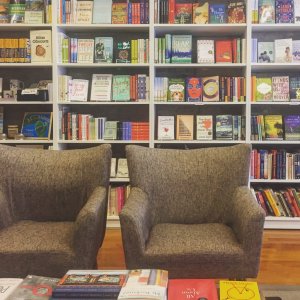 Two armchairs with bookshelves