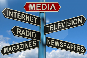 Street sign listing internet, television, radio, magazines, newspapers