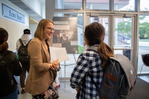 A Sponsor Mentor from the Human Rights First - Multidisciplinary Design Program project speaks with a prospective applicant at the Project Preview Night event in 2019.