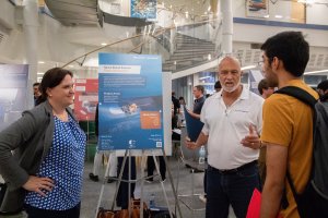 A Sponsor Mentor and a Faculty Mentor from the Northrop Grumman Solar Truss - Multidisciplinary Design Program project speak with a prospective applicant at the Project Preview Night event in 2019.