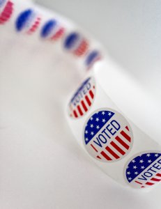 Roll of I Voted stickers on a white background Photo by On Unsplash.