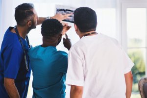 Healthcare workers reviewing scans