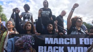 Photo of seven women holding a banner that reads "March for Black Women"