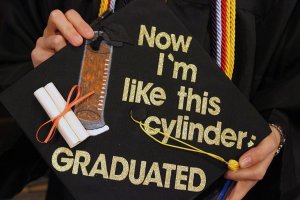 mortarboard with paper decoration, words: Now I'm just like this cylinder, graduated