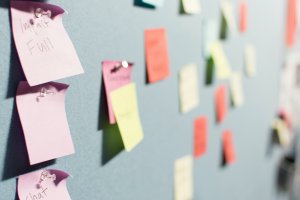 wall full of colorful sticky notes that have been tacked on during a brainstorming session