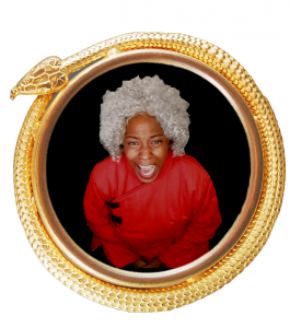 A woman with short, white, curly hair appears to scream while looking into the camera. This circular image is framed by a golden snake.