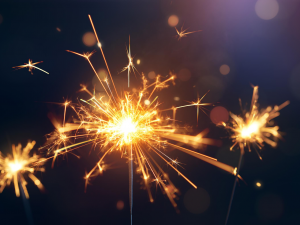 Three lit sparklers with a black background Three lit sparklers with a black background