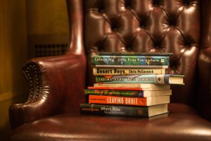 Books by Hopwood winners on a Hopwood Room wing chair