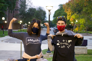 transfer students wearing and holding optiMize t-shirts